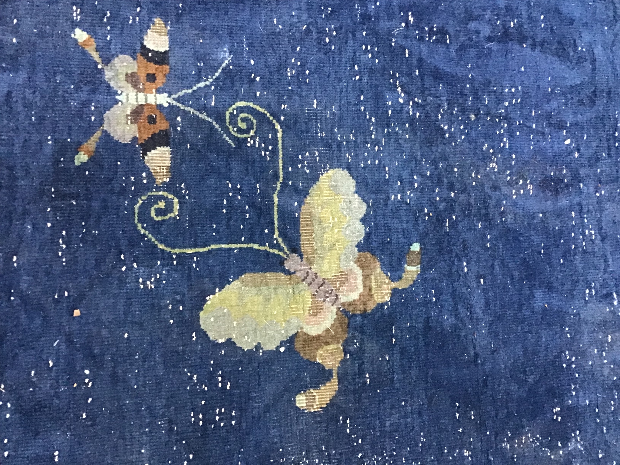 An early 20th century Chinese blue ground carpet woven with butterflies and flowering branches 450cm x 370cm
